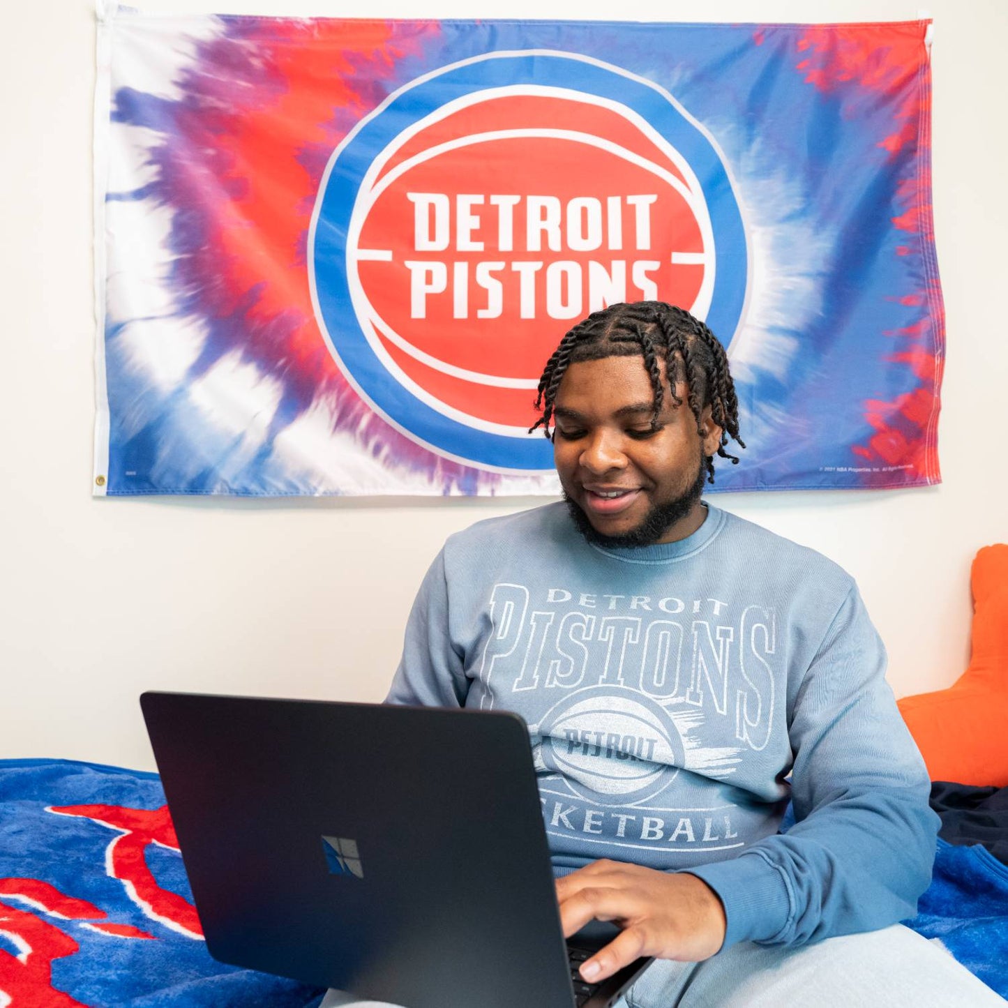 Student Wearing Detroit Pistons Sportiqe Sun Fade Crewneck Sweatshirt