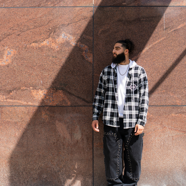 Model wearing Unisex Wild Collective Pistons 313 Hooded Flannel in Black and White - Front View