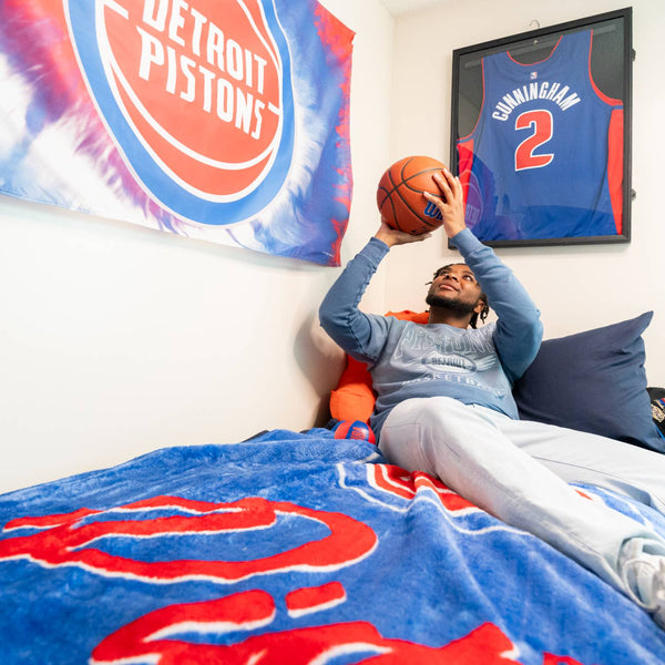 Student Playing With Pistons Alliance Full Size Basketball in Dorm Room