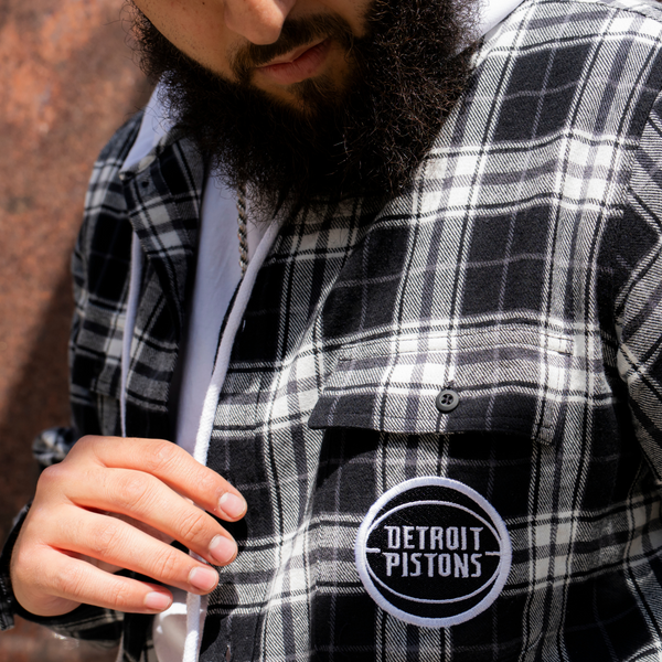 Model wearing Unisex Wild Collective Pistons 313 Hooded Flannel in Black and White - Chest detail View 