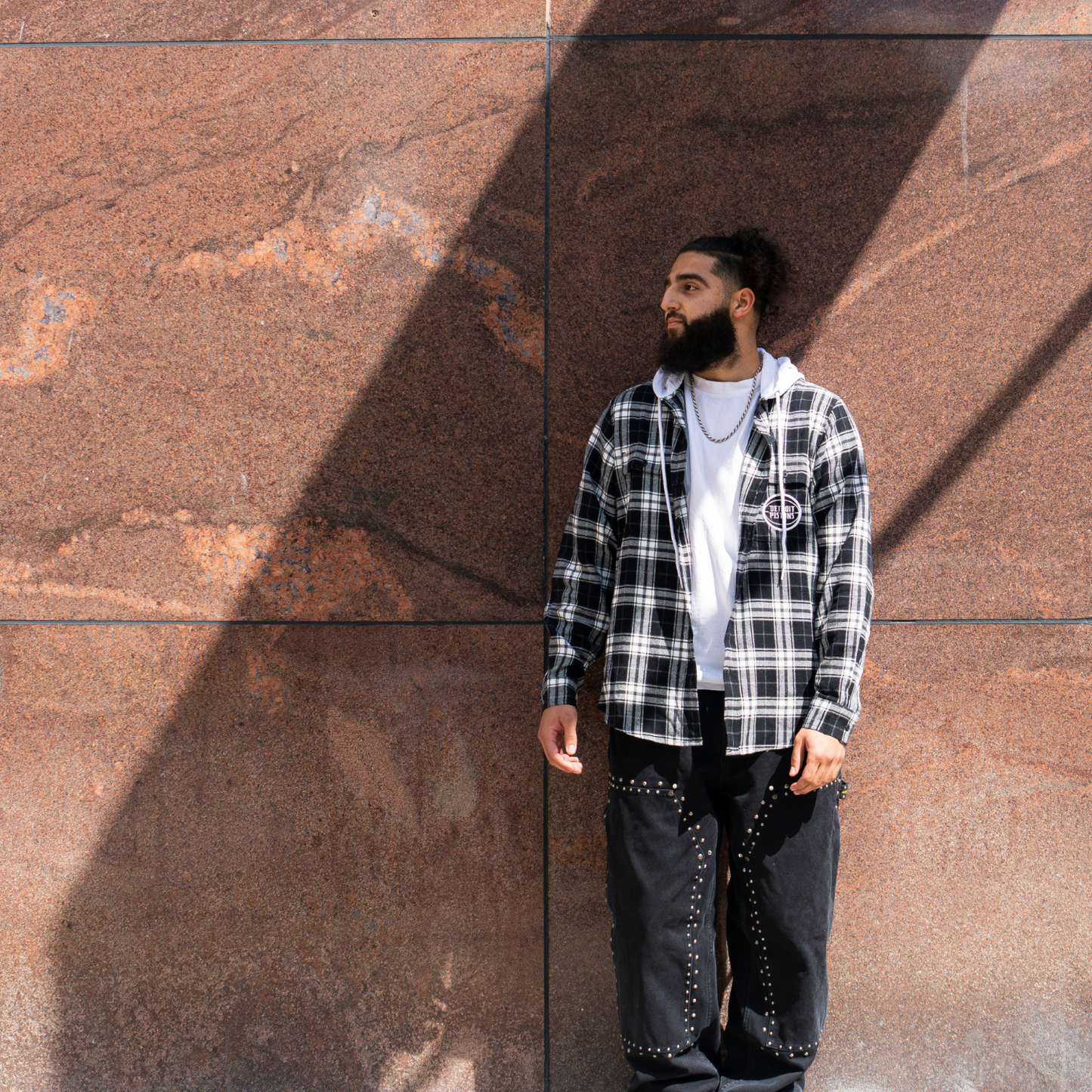 Model wearing Unisex Wild Collective Pistons 313 Hooded Flannel in Black and White - Front View