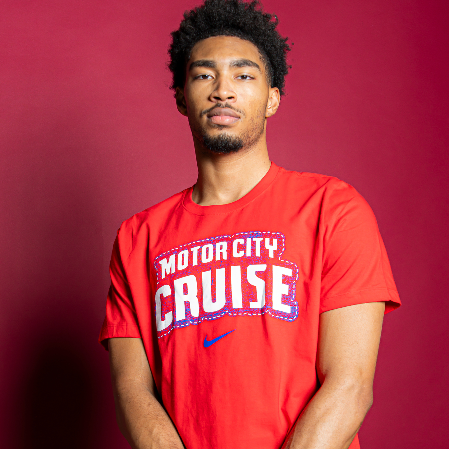 Model Wearing Motor City Cruise Nike Stacked T-Shirt in red - Front View