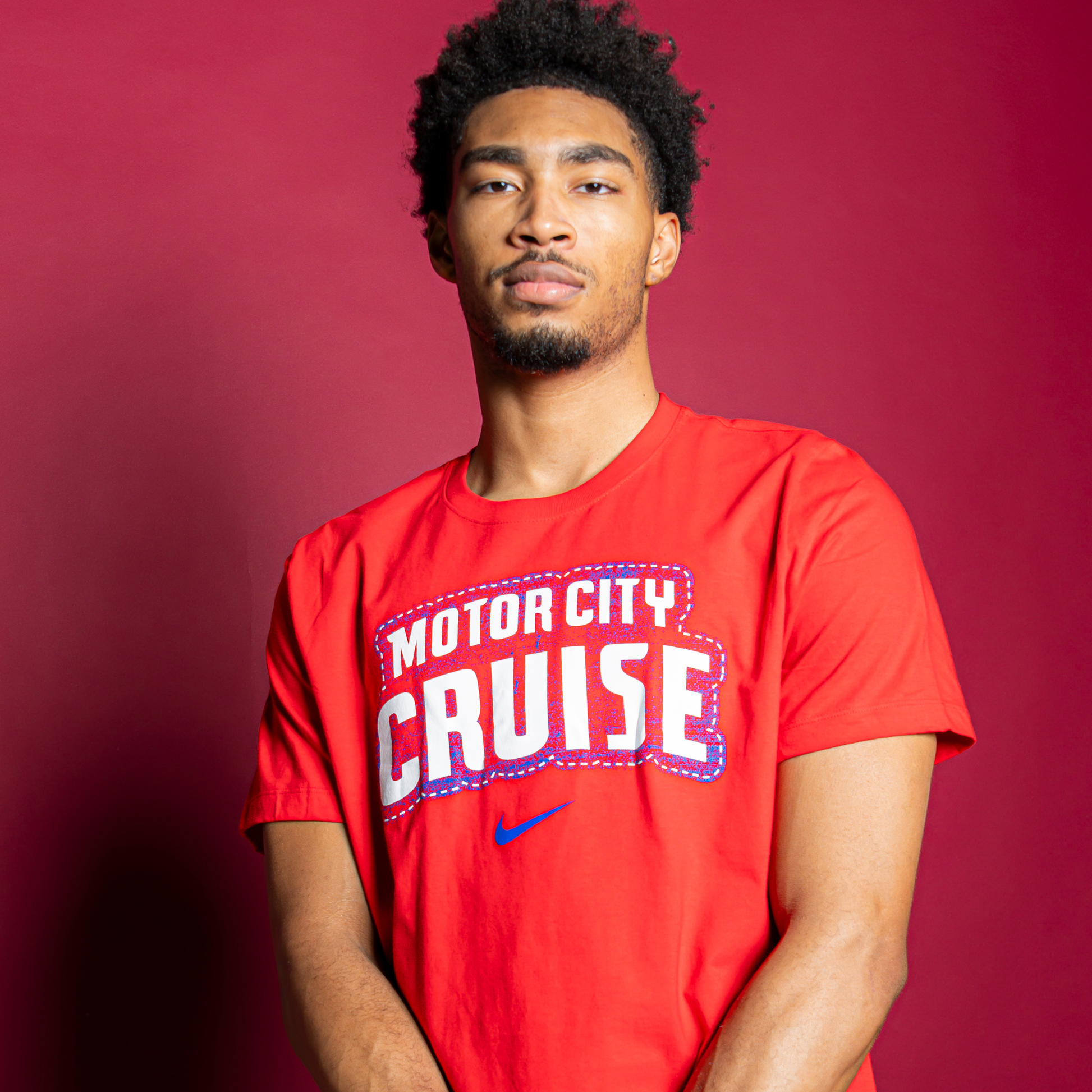 Model Wearing Motor City Cruise Nike Stacked T-Shirt in red - Front View