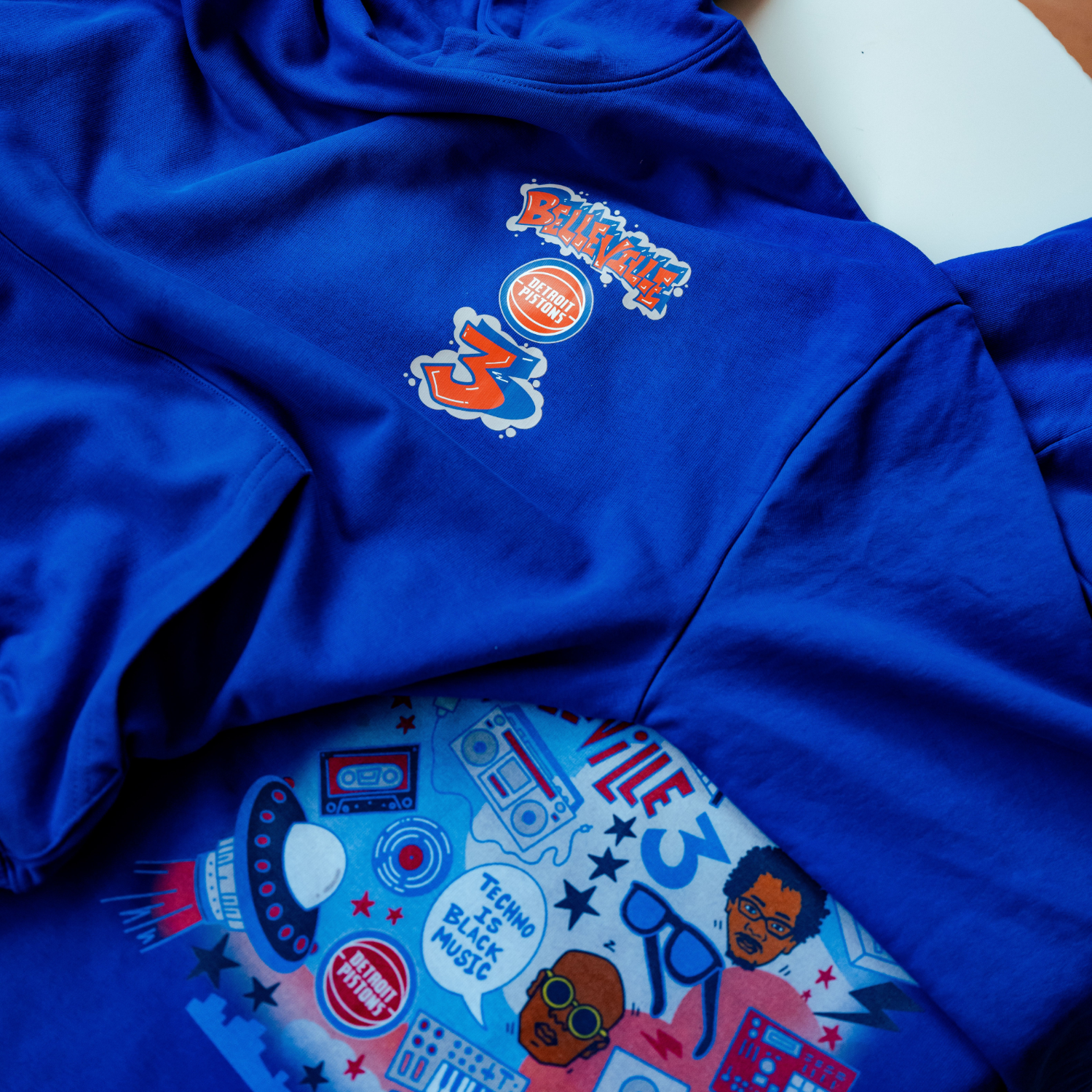 Detroit Pistons The Belleville Three Hoodie in Blue - Chest and Back Detail View