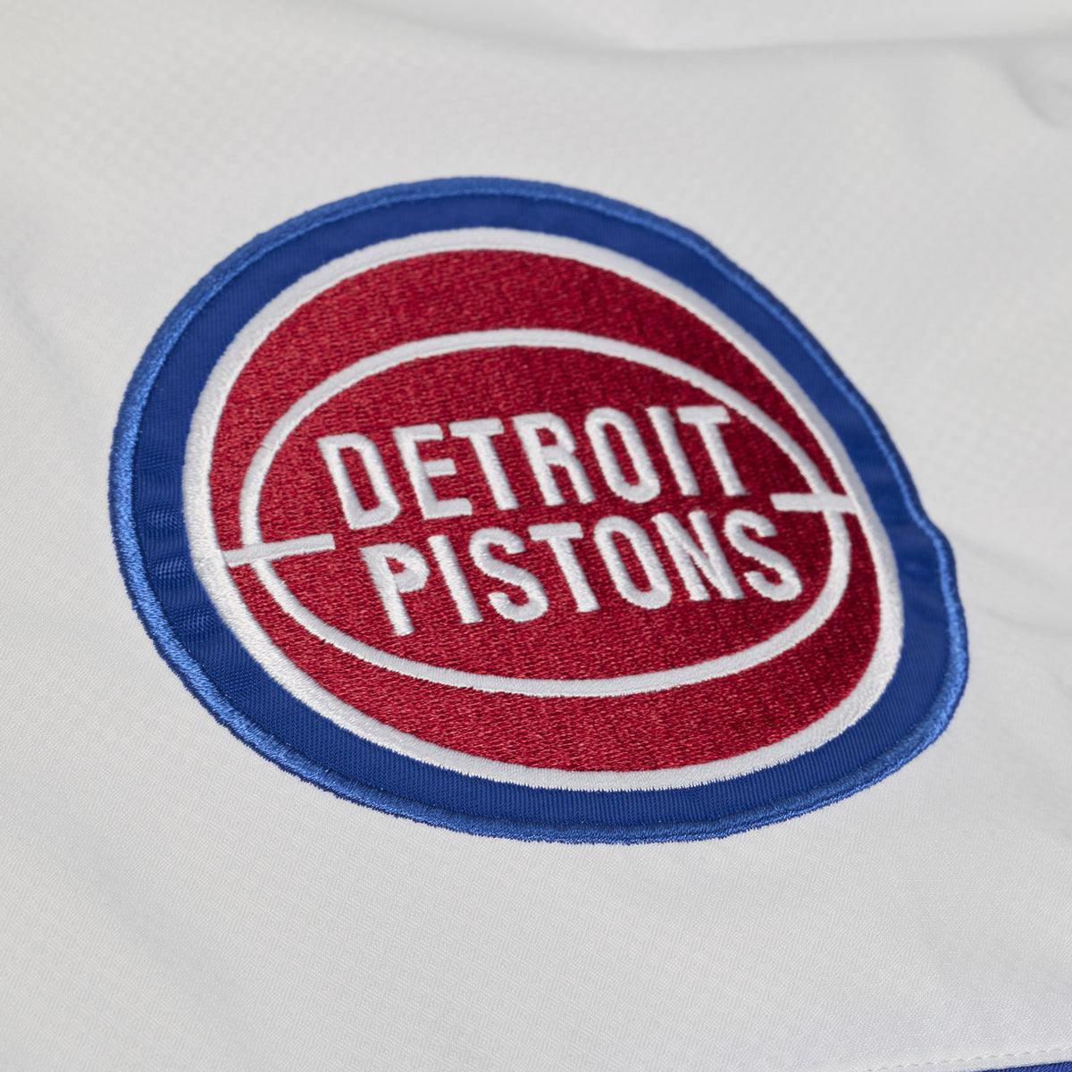 Detroit Pistons Mitchell & Ness Head Coach Anorak 1/2 Zip Jacket in White and Blue - Front Patch View