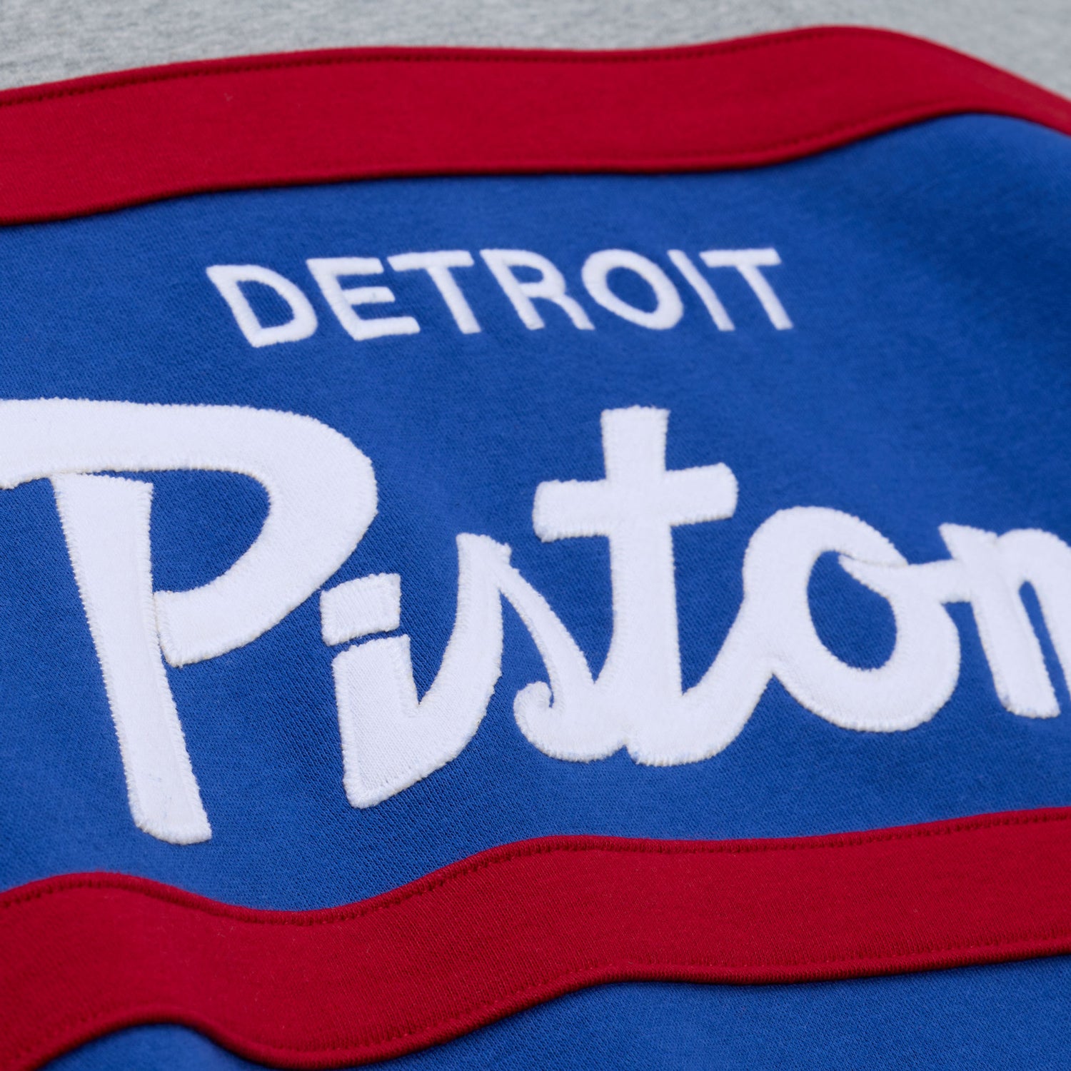 Detroit Pistons Mitchell & Ness Head Coach Hoodie in Grey, Blue, and Red - Chest Detail Front View