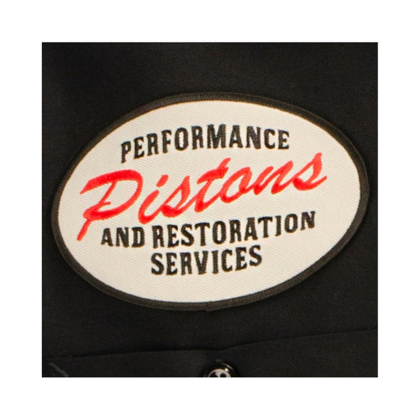 DETail Threads Pistons Garage Work Shirt in Black - Close Up View of Pistons Performance and Restoration Services logo